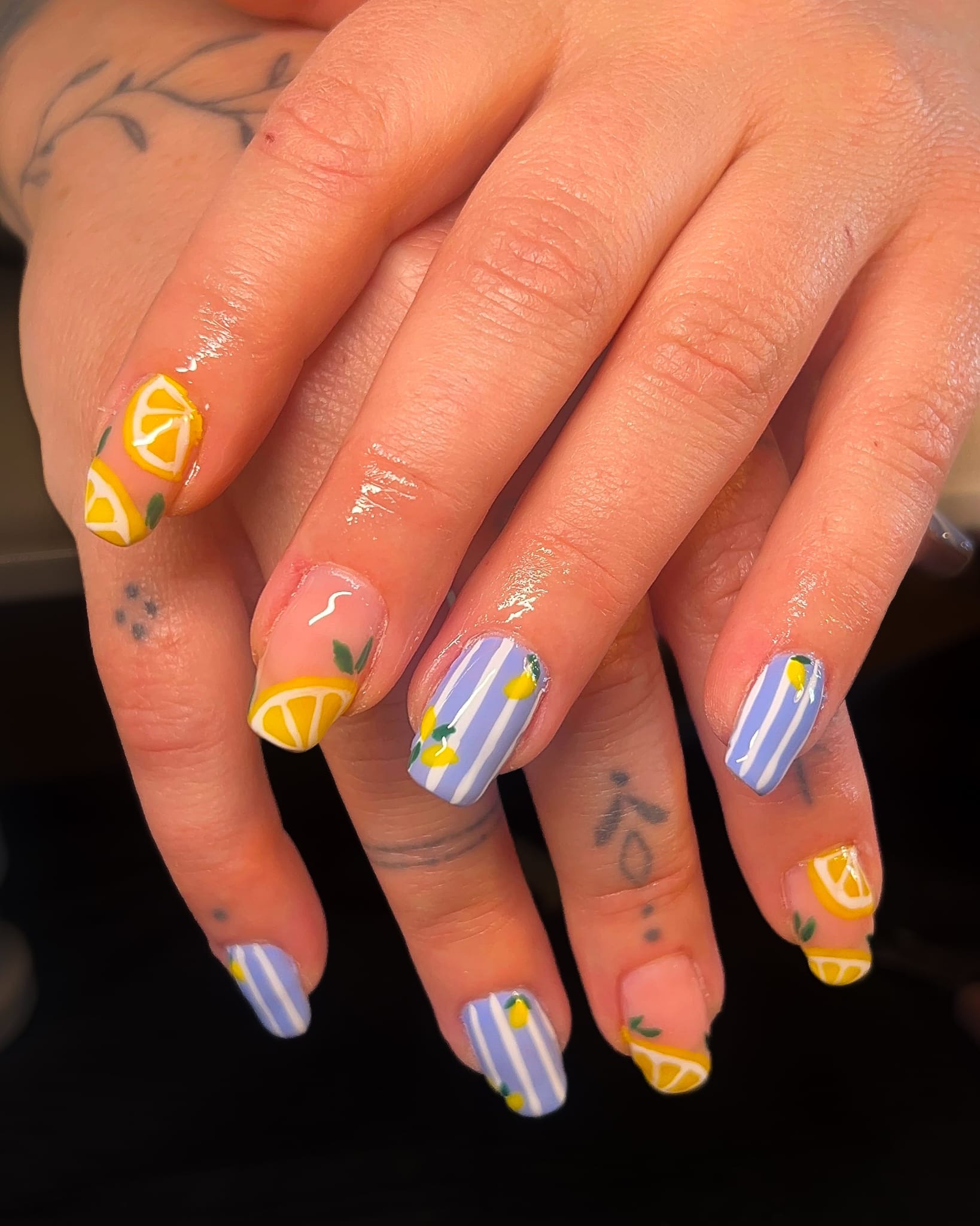 Lemon and lavender striped nail design